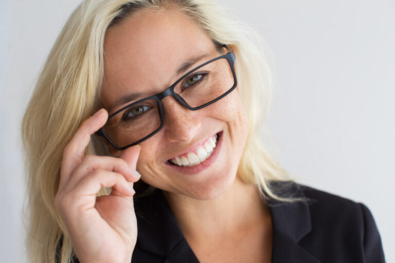 Close-up of cheerful young woman wearing glasses